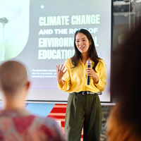 Headshot of person in a garden holding some plants.