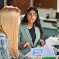 Man holding a pen writing in a notebook.