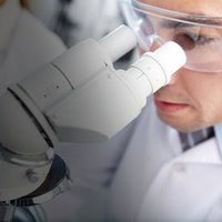 Man looking into microscope.