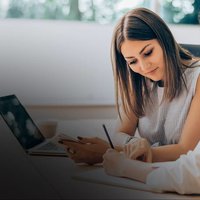 Two ladies working on a laptop.