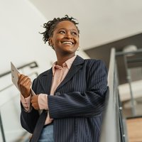 Image of smartly dressed woman smiling.
