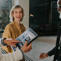 Woman pointing at magazine.