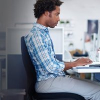 Man at a desk using a mouse.
